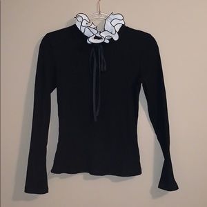 Ruffled black turtleneck sweater.